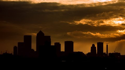 4K timelapse of the London skyline with Canary Wharf silhouetted against sunrise.