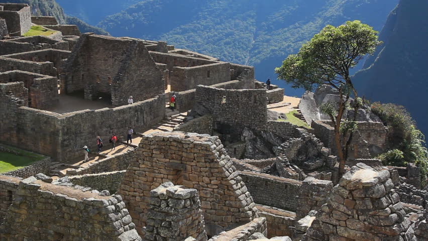 MACHU PICCHU, PERU - AUGUST 2014: Tourists visiting Machu Picchu, Peru - UNESCO World Heritage Site