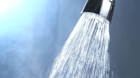 Shower head, water flowing, steam rising, shower curtain in background