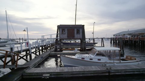Newport Harbor with dock house and boat at sunset and boats