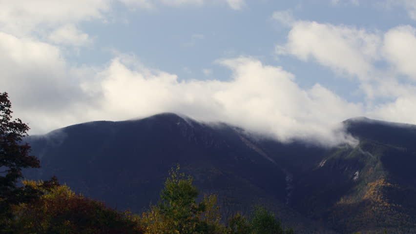 New Hampshire mountain with fall foliage and clouds as time lapse