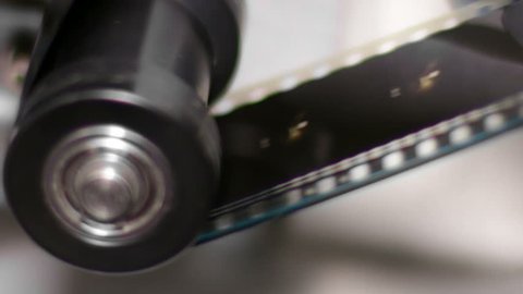 35mm Film Projector Gear Projecting Movie.
Cinema projector film gear detail. 
35mm film projection cinema technical footage.
Film Technician mounting a 35mm film reel in a film festival.
