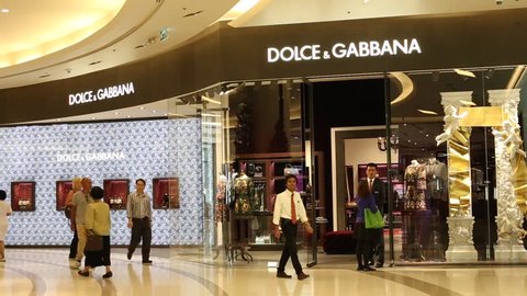 BANGKOK,THAILAND - NOVEMBER 18, 2014:Unidentified people walking near the Dolce & Gabbana store in Siam Paragon Mall. With 300,000 sq m of retail space Siam Paragon is one of the world's largest malls