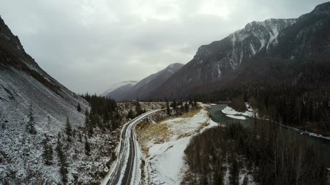 Flight over the Mountain Road and River in Winter Stockvideo
