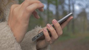 Woman typing on smart phone touch screen in nature 1920X1080 HD slow motion footage - Outdoor typing on mobile phone display 1080p FullHD slow-mo video