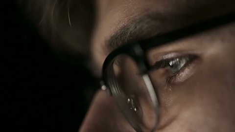 Portrait of a young man with glasses who works at night.  Close up