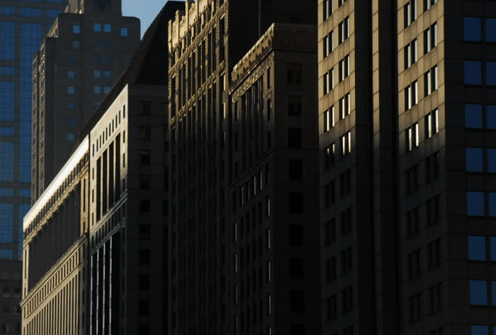 Sun rises on buildings in city time lapse