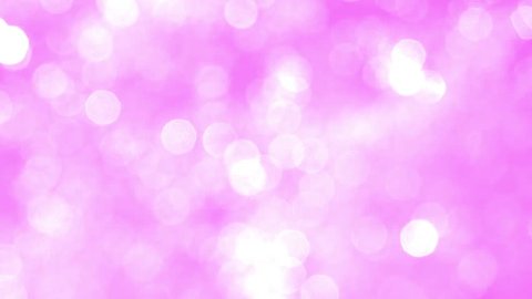 Blurred Light Pink Sparkles. Shining particles move randomly on a light pink background