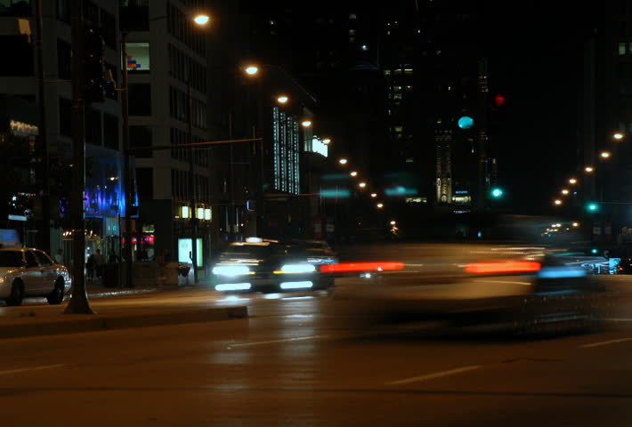 Traffic driving on a city street at night time lapse