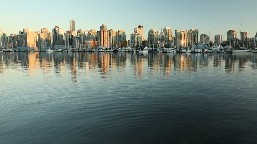 Downtown Vancouver Dusk Coal Harbor. Downtown Vancouver skyline at sunset looking across Coal Harbor from Stanley Park, British Columbia, Canada.
