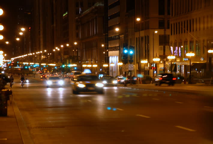 Traffic driving on a city street at night time lapse