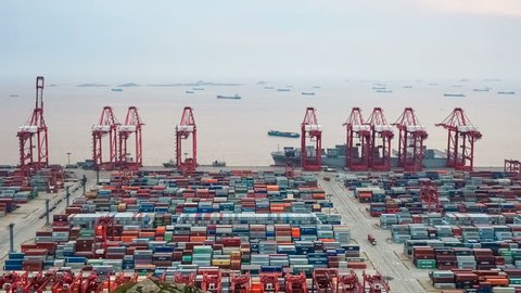 time lapse of busy container terminal in shanghai at dusk
