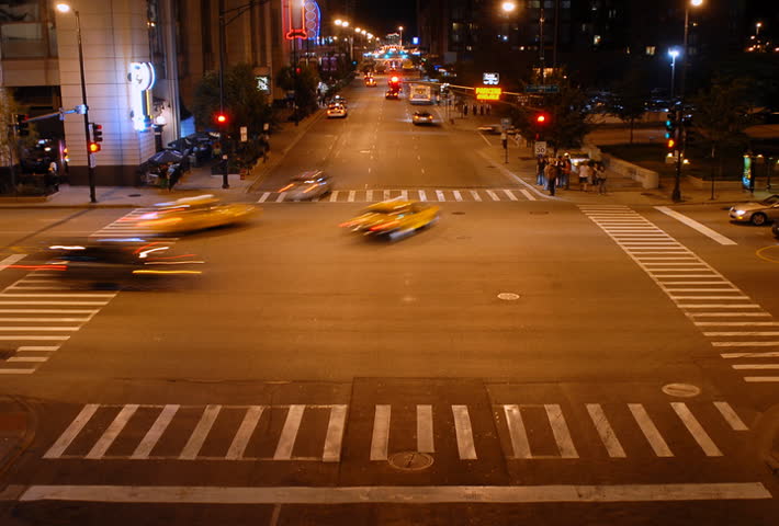 Overhead view of city intersection at night time lapse