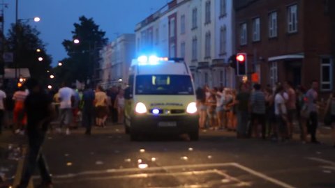 BRISTOL - July 6: Ambulance Driving Through Crowd at St Pauls Carnival - July 6 2013 in Bristol England