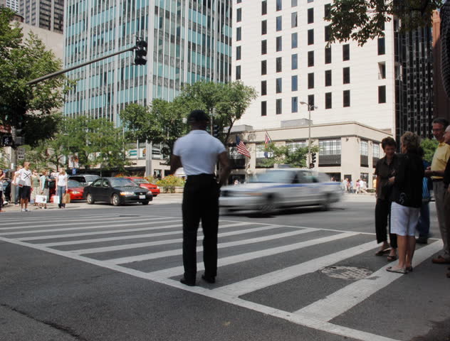 Crowds crossing urban street time lapse