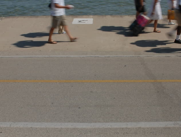 Daytime city waterfront walkway time lapse