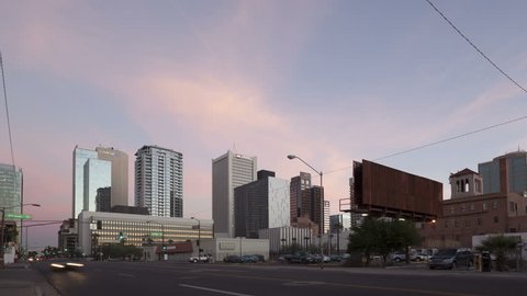 PHOENIX, USA - JAN 11, 2014: 4K Time lapse zoom out traffic Phoenix downtown at sunset and twilight with skyscrapers in the background