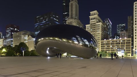 CHICAGO, USA - Oct 21, 2011: 4K Time lapse zoom out Cloud Gate sculpture and downtown skyline buildings at night. Cloud Gate is the famous landmark of Chicago in Millennium Park.