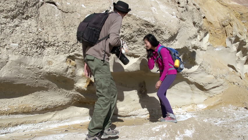 Paleontologists Expedition. Two paleontologist considering fossils sticking out of the walls of the canyon