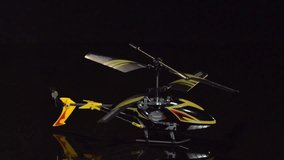 model helicopter takes off on a black background