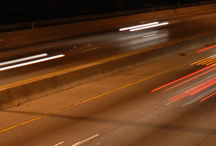 Speeding cars at night rush hour motion blur