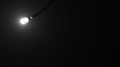 Light bulb animated on black background