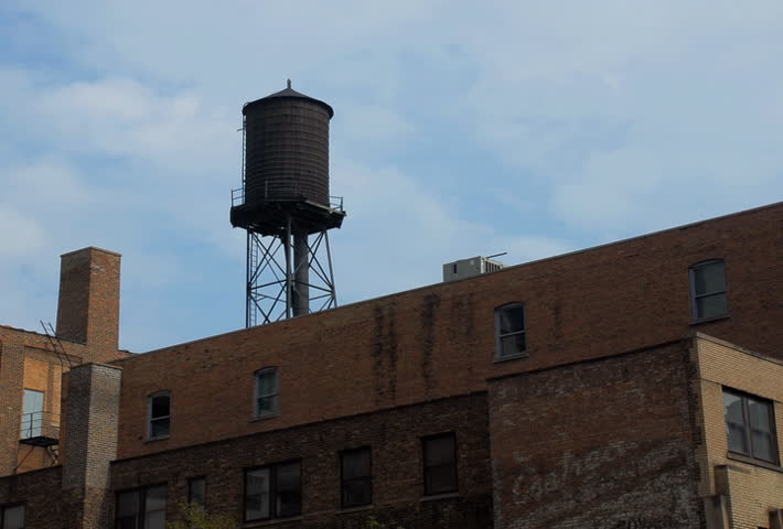 City water tower with clouds time lapse