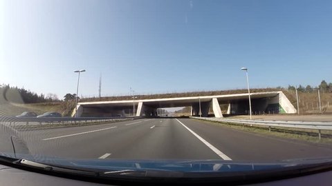 vehicle shot - approaching wildlife crossing, ecoduct Mollebos across highway A12 , Driebergen, The Netherlands. A wildlife crossing allows animals to cross a human-made barrier safely