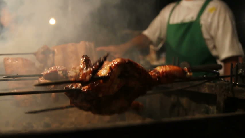 chicken roasting in a market stall