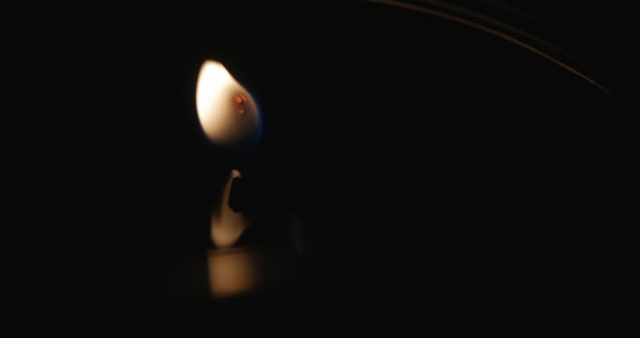 Close up shots of a candle wick flame burning sensually with reflections. Macro | Shutterstock HD Video #8040997