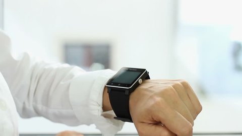Woman making gestures on a wearable smartwatch computer device, close up
 Stock Video