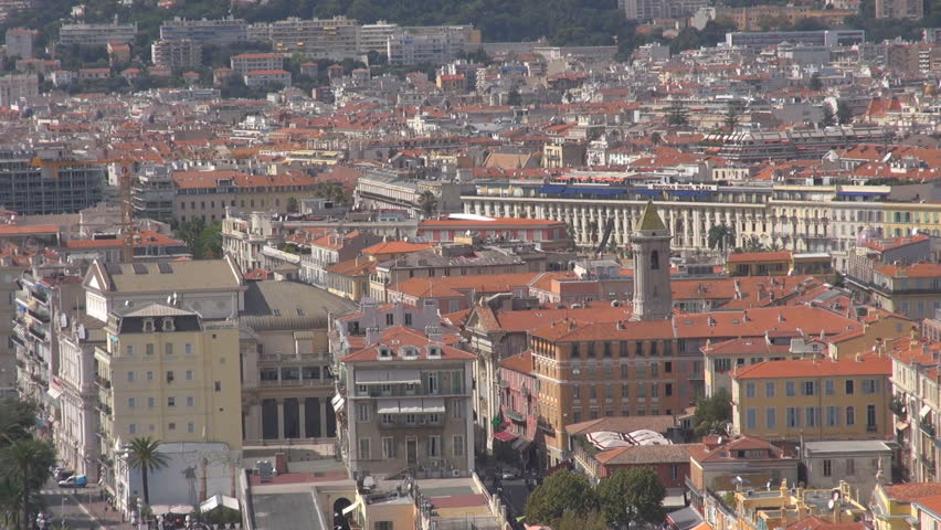 NICE - FRANCE, SEPTEMBER 9, 2013, Pan left of aerial view of Negresco hotel and sea beach with traffic street in sunny day