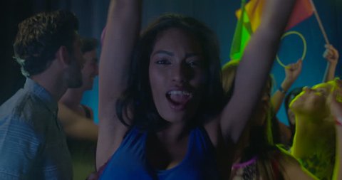 Woman dancing with friends and having fun in nightclub