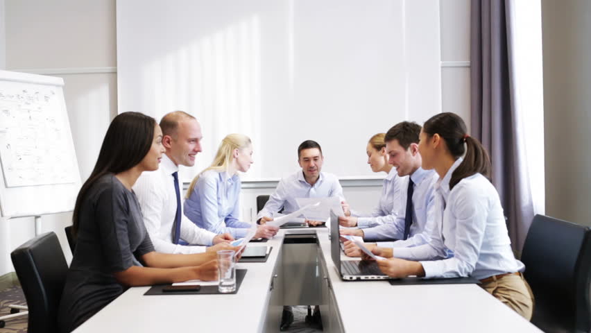 Business, teamwork, people and technology concept - smiling business team with laptop computers, papers and smartphones showing triumph gestures in office | Shutterstock HD Video #8047654