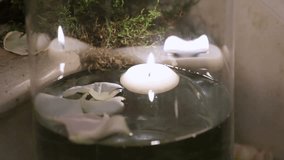 Group of burning candles with decorations on marble floor