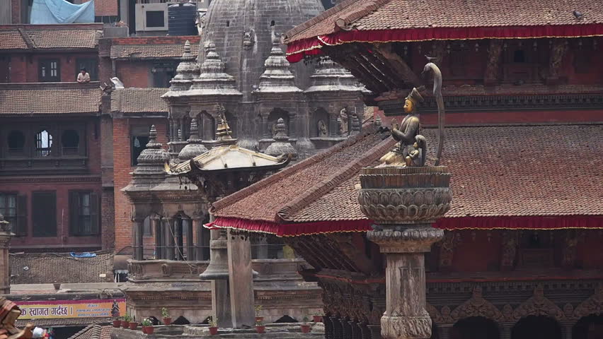 Statue of mall king and ancient Newa buildings at Patan Durbar Square in Kathmandu, Nepal.