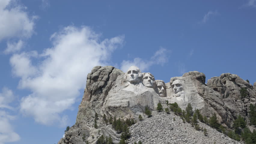 4K Time lapse medium close up  of Mt. Rushmore National Memorial Park in South Dakota. Sculptures of former U.S. presidents: George Washington,Thomas Jefferson, Theodore Roosevelt and Abraham Lincoln.