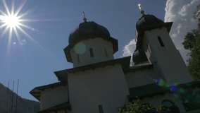 Monastery Mraconia on Danube river bank 4K 2160p UHD video - Sun flare over manastirea Mraconia Romanian monastery near river Danube 4K 3840X2160 UHD footage