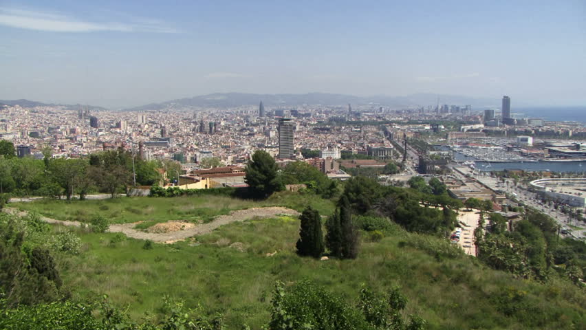 View of Barcelona Spain with park on hill and city in background
