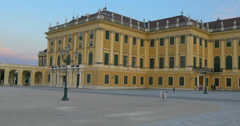 Pan right motion video of Schonbrunn Palace building, famous baroque architecture, summer tourism travel landmark in Vienna city park at sunset, Austria, Europe. Old imperial residence castle in Wien.