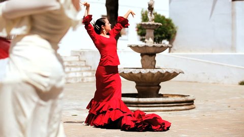 Two ladies dancing traditional flamenco in town square in Seville, Spain 