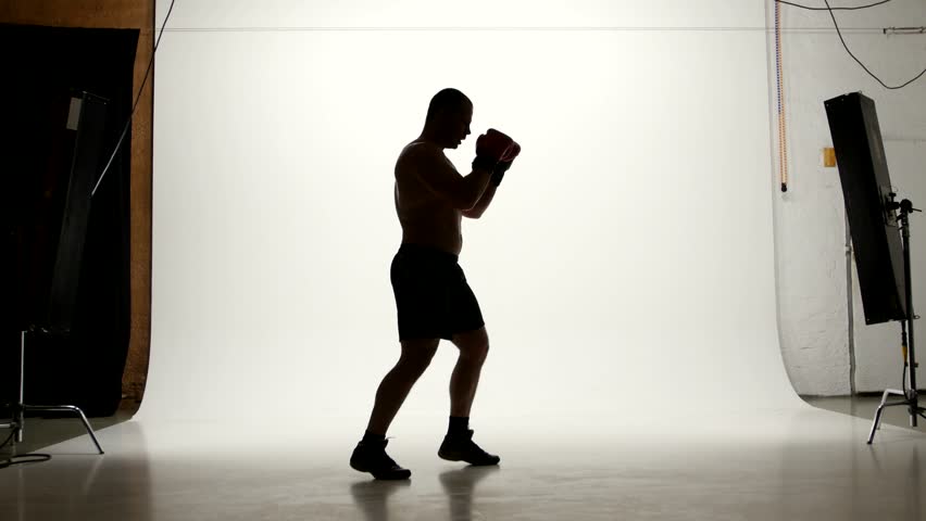 one caucasian man exercising boxing boxer workout fitness in silhouette studio  isolated on white background