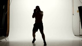 one caucasian man exercising boxing boxer workout fitness in silhouette studio  isolated on white background