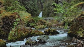 a shot of the river and waterfall in the columbia river gorge