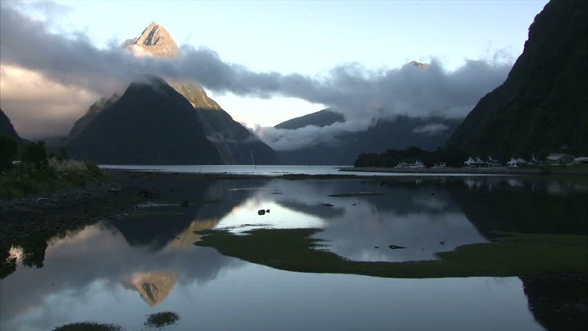 Sunrise flowing clouds over the hills in Milford Sound Bay. Milford Sound, New Zealand, Southern Island
