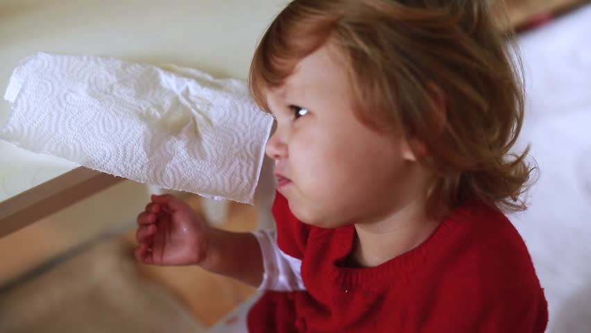 Adorable little girl pours a lot of paint on all studio.