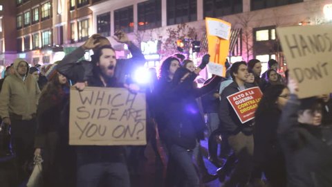 PROVIDENCE, RI - DEC 1: People protest the streets in reaction to the Ferguson shooting, taken on December 1, 2014 in Providence, Rhode Island. Sequence of multiple clips with audio.