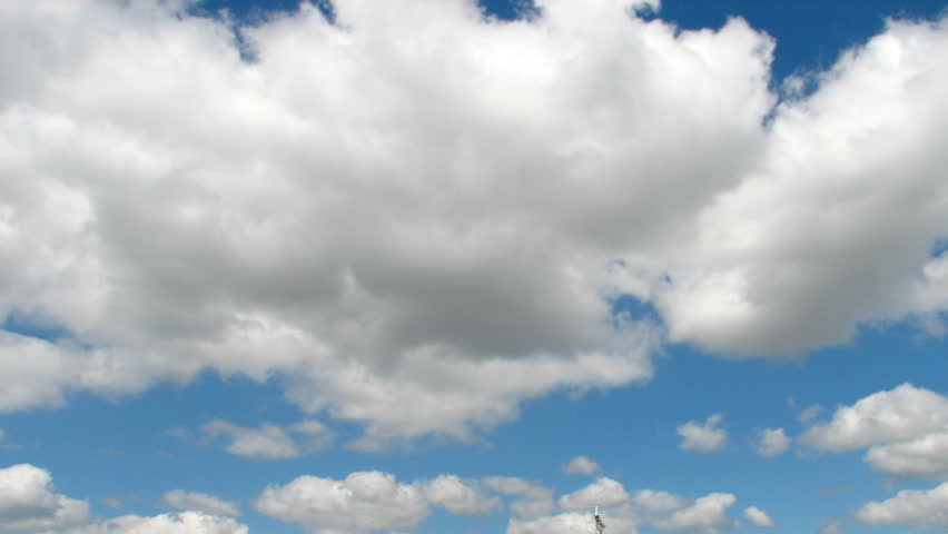 Time lapse sequence of morphing white clouds over a blue sky (France, west