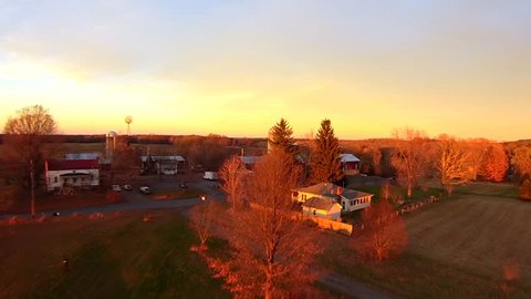 Working farm aerials, sunset light, slow rise. Upstate New York. Float over views of farm, in late afternoon late fall light, very clear light. Aerial Farm views, HD 60FPS close up and personal. 