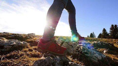 foot steps of hiker hiking outdoors. walking feet on rocky terrain